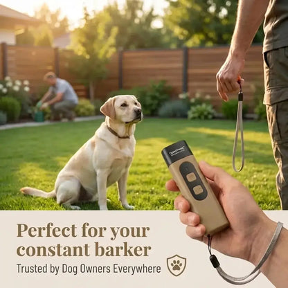 QuietPaws™ Gentle Bark Control held by a person with a dog sitting on grass in the background.