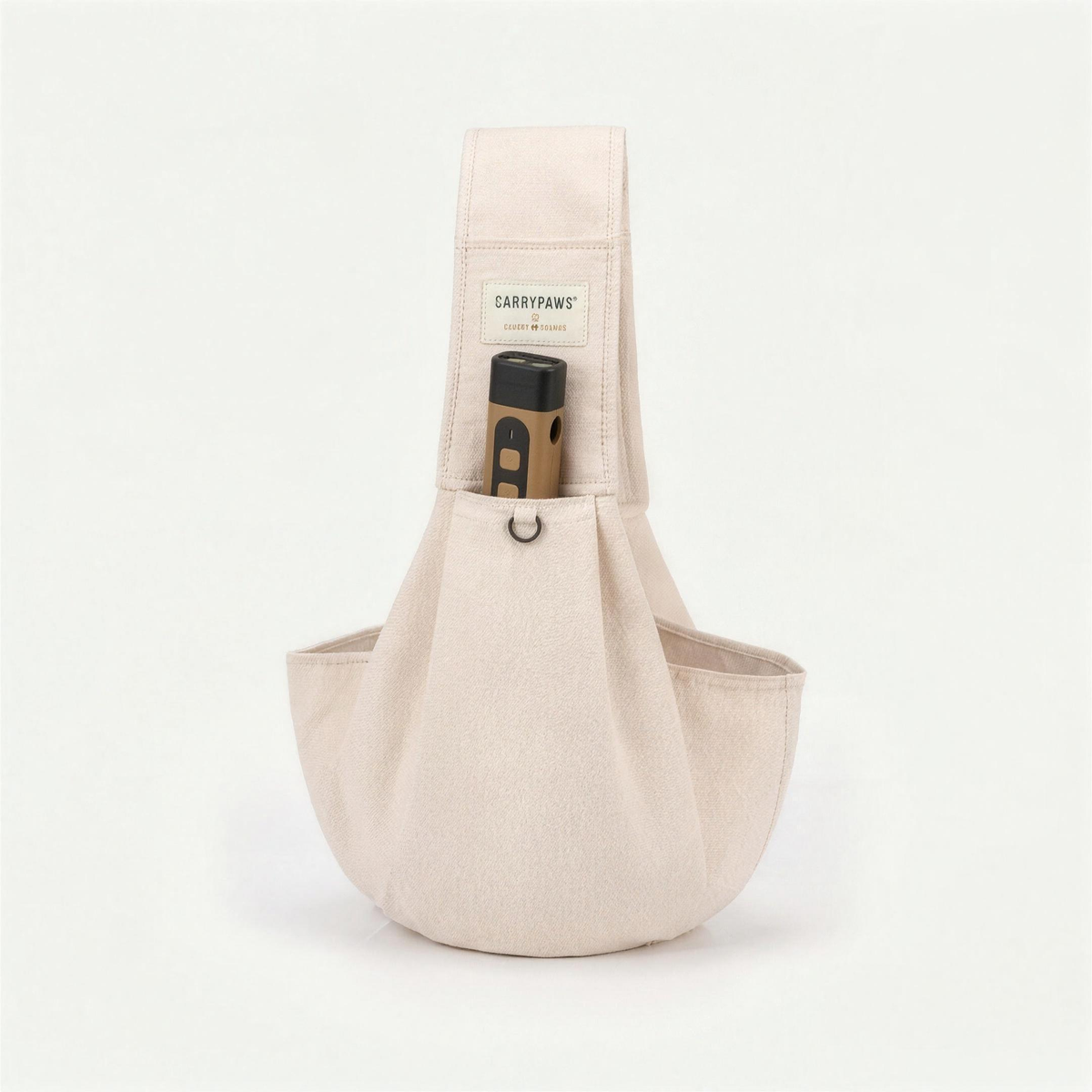 Beige CarryPaws™ dog sling carrier with the brown QuietPaws™ bark control device in its front pocket